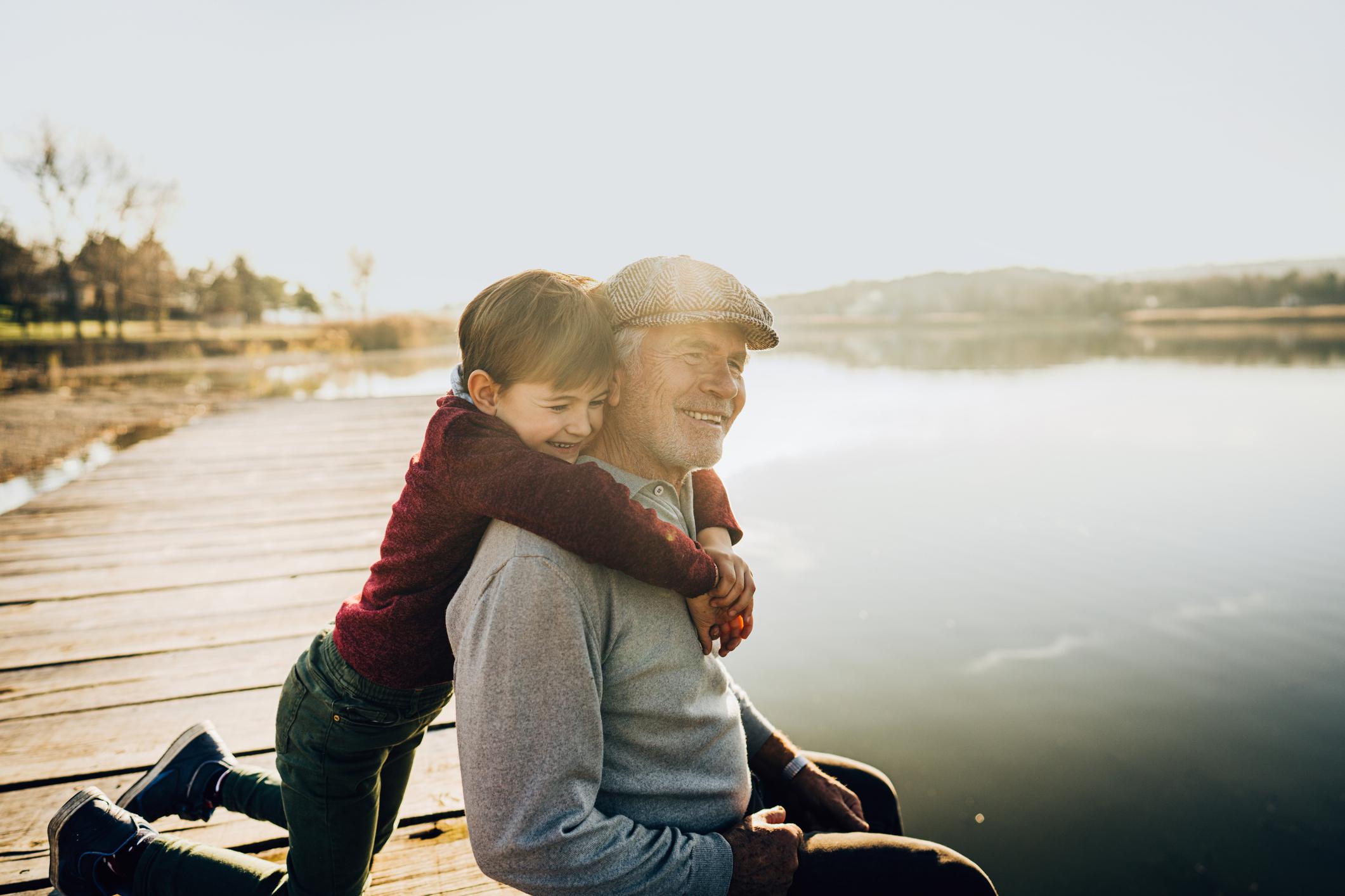 Grandfather and grandson on a lake dock